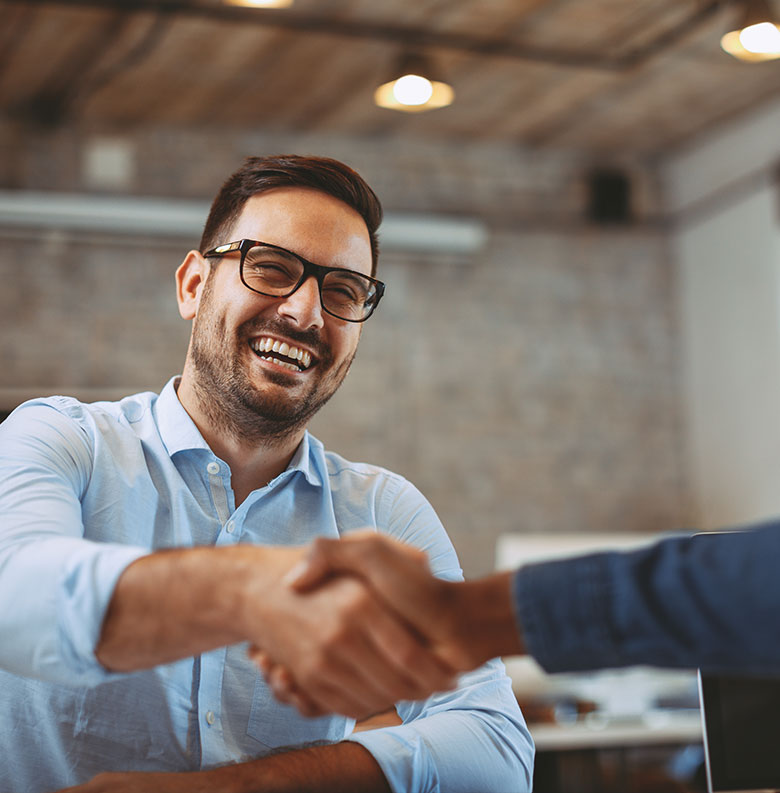 Finance professional greeting a colleague in the workplace